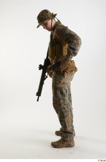 Casey Schneider in WDL Marpat Pose 5 loading gun standing…